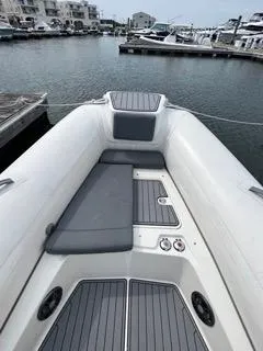 Slide: The Image of 2026 Brig Eagle 8 boat interior with gray seating, docked at a marina. - 25