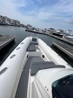 Slide: The Image of 2026 Brig Eagle 8 boat docked in a marina, featuring sleek design and comfortable seating. - 28