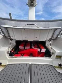 Slide: The Image of 2026 Brig Eagle 8 storage compartment with life jackets and equipment under a blue sky. - 30