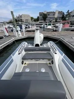 Slide: The Image of 2026 Brig Eagle 8 boat docked at a marina, featuring sleek seating and modern design. - 31