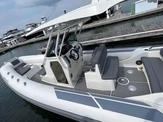 Slide: The Image of 2026 Brig Eagle 8 boat docked at marina, featuring sleek design and spacious seating. - 32