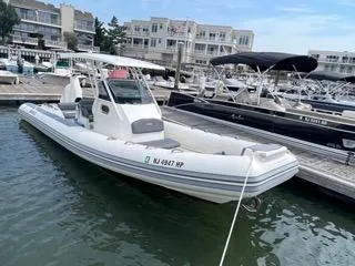 Slide: The Image of 2026 Brig Eagle 8 boat docked at a marina with surrounding buildings. - 33