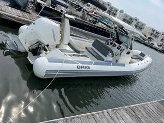 Slide: The Image of 2026 Brig Eagle 8 boat docked in marina, featuring sleek design and modern outboard motor. - 35
