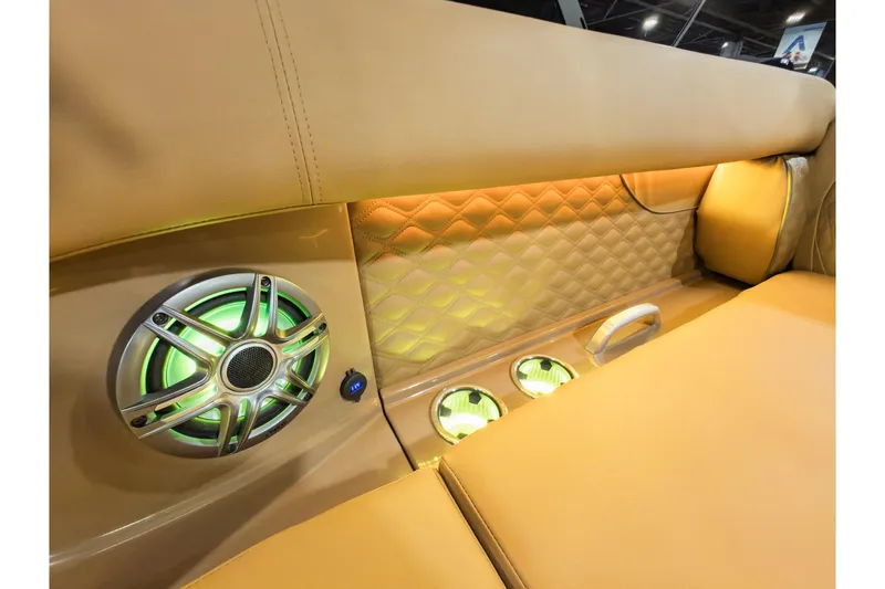 Slide: The Image of Luxurious interior of 2026 Godfrey SanPan 2500 SBC with illuminated speaker and quilted upholstery. - 13