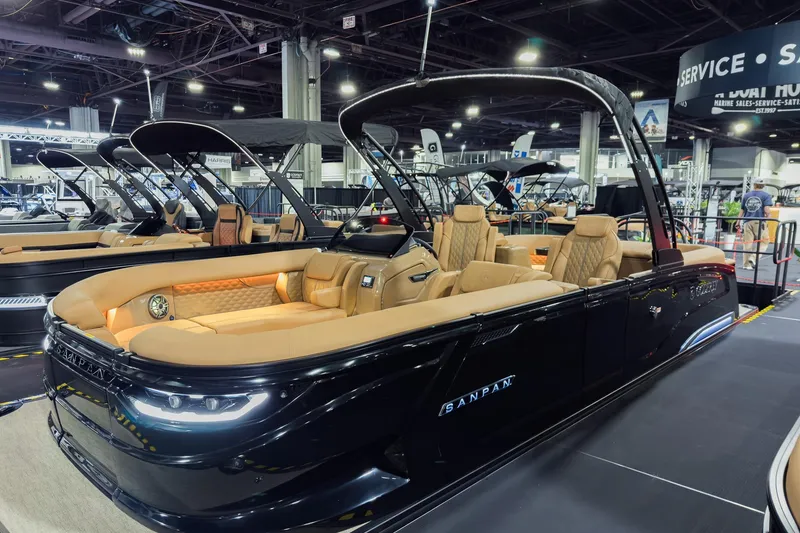 Slide: The Image of 2026 Godfrey SanPan 25' Split Bench Co-Captain pontoon boat on display indoors. - 42