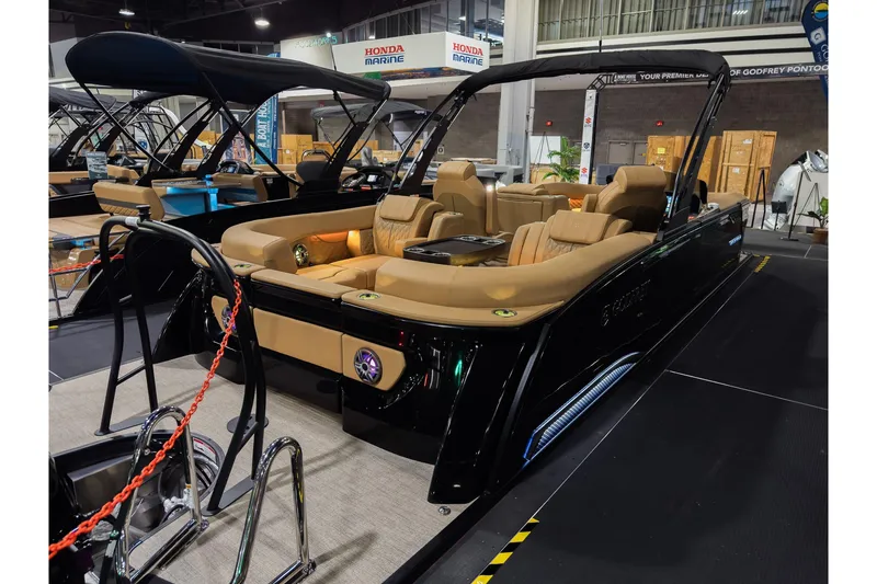 Slide: The Image of 2026 Godfrey SanPan 25' Split Bench Co-Captain pontoon boat displayed indoors. - 5
