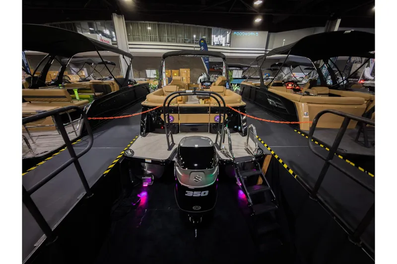 Slide: The Image of 2026 Godfrey SanPan 25' Split Bench Co-Captain boat displayed indoors with powerful engine. - 6