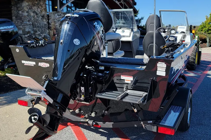 Slide: The Image of 2019 Tracker Pro Guide V-175 Combo boat with Mercury outboard motor, parked on trailer. - 3