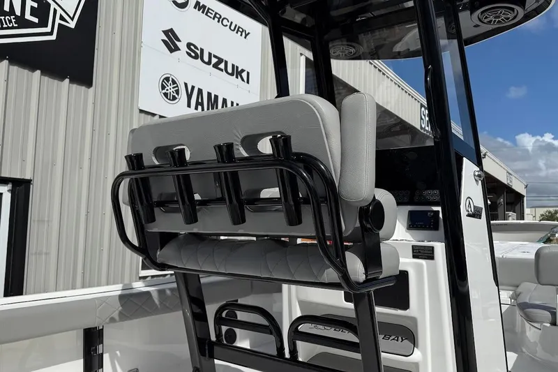 Slide: The Image of 2026 Blazer Bay 2440 boat interior with rod holders and branded signage in background. - 11