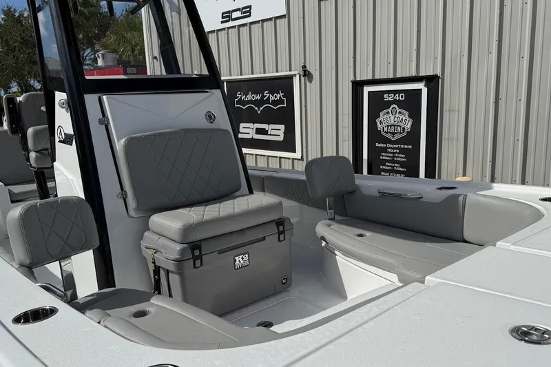 Slide: The Image of 2026 Blazer Bay 2440 boat interior with gray seating and K2 cooler. - 13