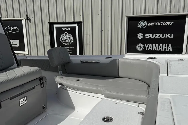 Slide: The Image of 2026 Blazer Bay 2440 boat interior with gray seating and K2 cooler. - 14