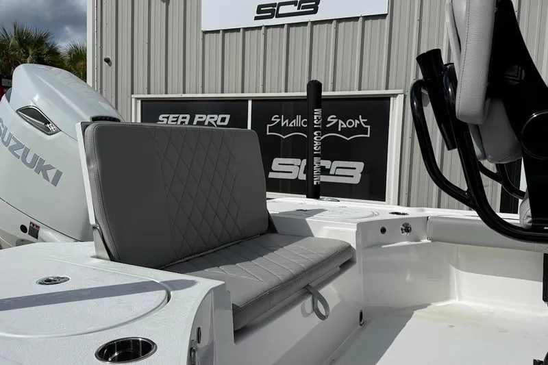Slide: The Image of Blazer Bay 2440 boat interior with Suzuki engine, 2026 model, featuring gray seating. - 6