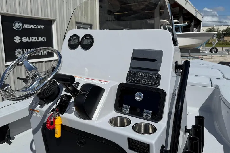 Slide: The Image of 2026 Blazer 675 Ultimate Bay boat dashboard with steering wheel and control panel. - 11