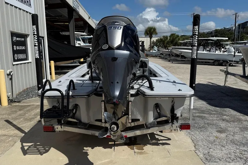 Slide: The Image of 2026 Blazer 675 Ultimate Bay boat with powerful outboard motor at a marine dealership. - 12