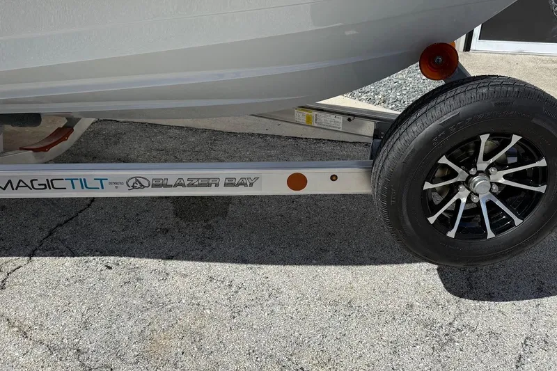 Slide: The Image of Trailer for 2026 Blazer 675 Ultimate Bay boat with Magic Tilt branding. - 2