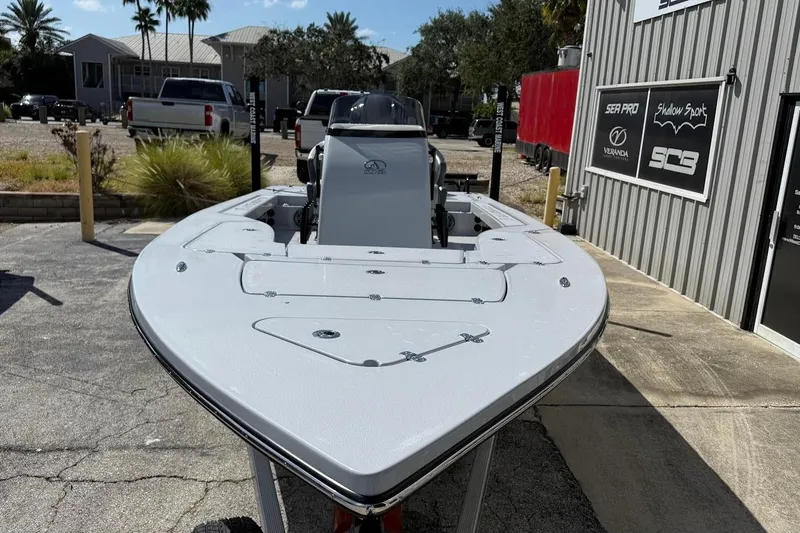 Slide: The Image of 2026 Blazer 675 Ultimate Bay boat parked outdoors near a building. - 3