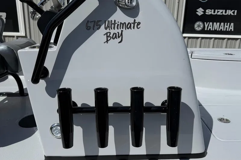 Slide: The Image of 2026 Blazer 675 Ultimate Bay boat console with rod holders and brand logos. - 8