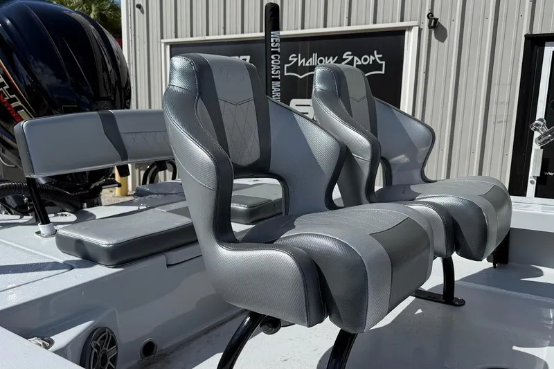 Slide: The Image of 2026 Blazer 675 Ultimate Bay boat seats, sleek gray design, outdoor setting. - 9