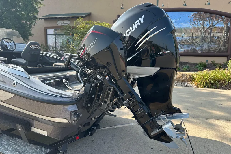 Slide: The Image of 2018 Triton 216 Fishunter boat with Mercury Verado engine, parked outdoors. - 4