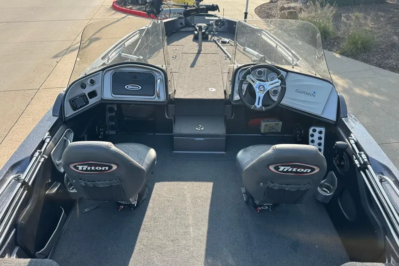Slide: The Image of 2018 Triton 216 Fishunter boat interior with dual seats and Garmin navigation system. - 9