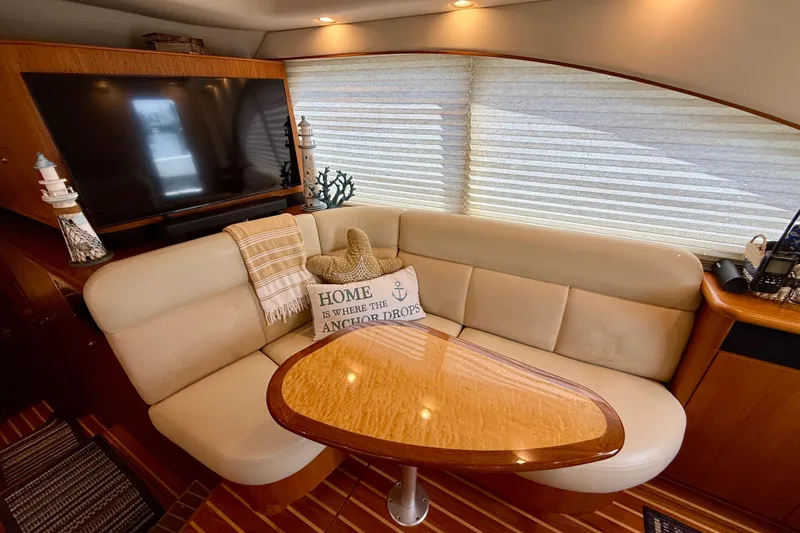 Slide: The Image of Luxurious 2006 Tiara Yachts 3900 Convertible interior with cozy seating and elegant decor. - 13