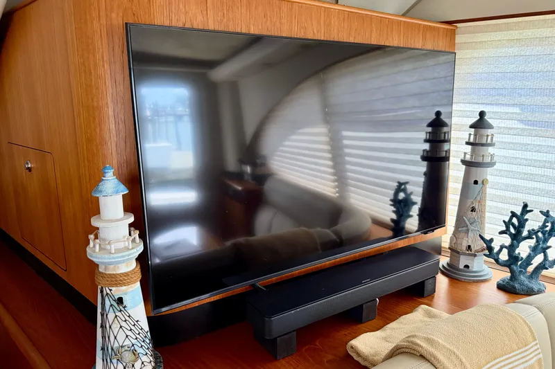 Slide: The Image of Interior of 2006 Tiara Yachts 3900 Convertible with TV and nautical decor. - 14