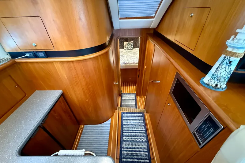 Slide: The Image of 2006 Tiara Yachts 3900 Convertible interior with wood finish and modern amenities. - 17