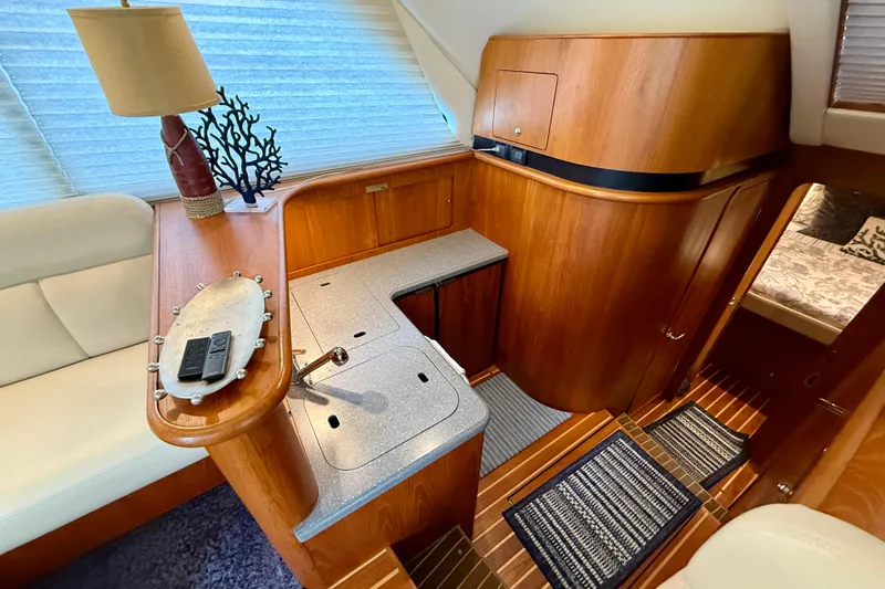 Slide: The Image of Luxurious interior of 2006 Tiara Yachts 3900 Convertible with elegant wood finishes. - 18