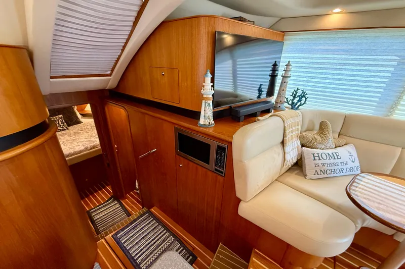 Slide: The Image of Luxurious interior of 2006 Tiara Yachts 3900 Convertible with cozy seating and nautical decor. - 21