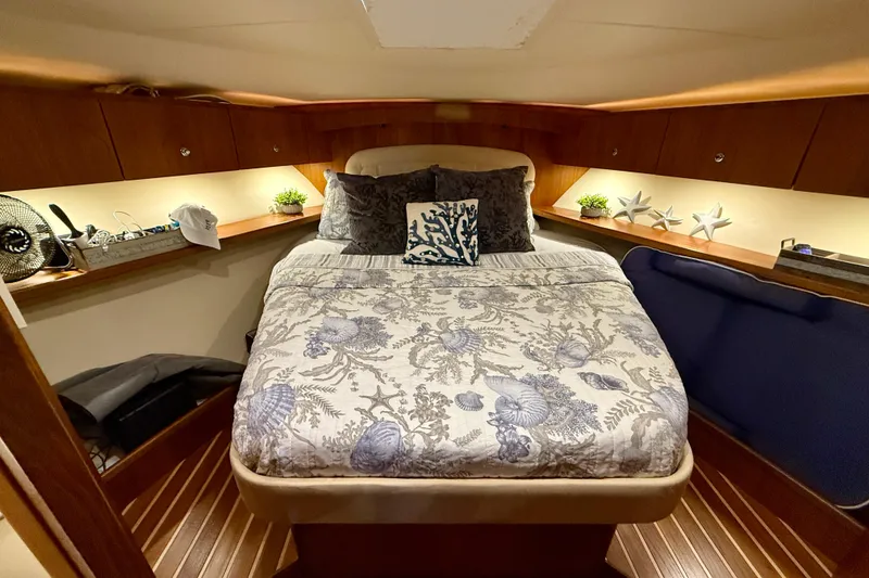 Slide: The Image of Luxurious cabin interior of 2006 Tiara Yachts 3900 Convertible with elegant bedding and decor. - 22