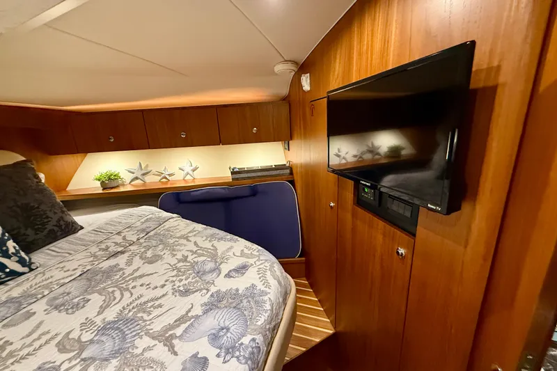Slide: The Image of Luxurious 2006 Tiara Yachts 3900 Convertible cabin with elegant wood paneling and modern amenities. - 23