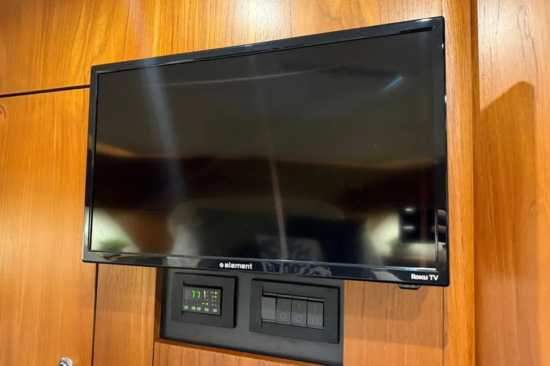 Slide: The Image of Flat-screen TV on 2006 Tiara Yachts 3900 Convertible's wooden interior wall. - 24