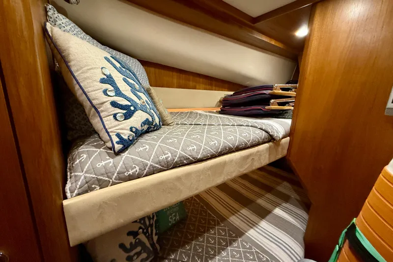 Slide: The Image of Cozy cabin interior of 2006 Tiara Yachts 3900 Convertible with nautical-themed bedding. - 26