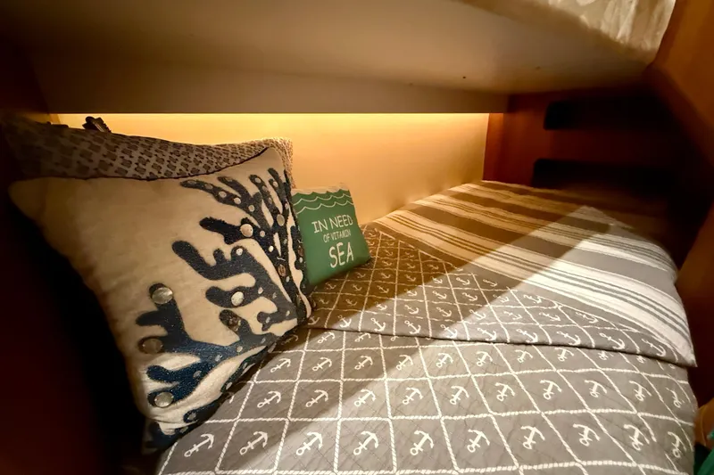 Slide: The Image of Cozy cabin bed in 2006 Tiara Yachts 3900 Convertible with nautical-themed pillows. - 27