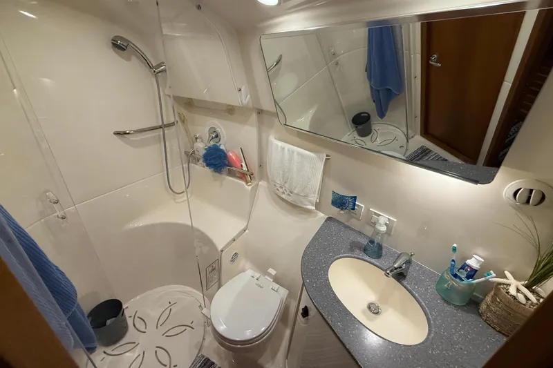 Slide: The Image of Bathroom interior of 2006 Tiara Yachts 3900 Convertible, featuring shower, sink, and toilet. - 28