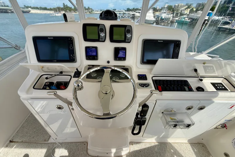Slide: The Image of 2006 Tiara Yachts 3900 Convertible helm with advanced navigation systems and steering wheel. - 32
