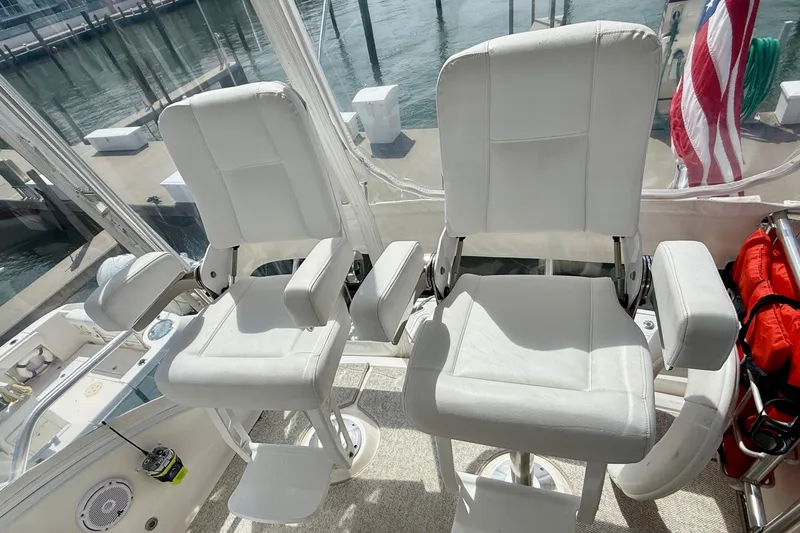 Slide: The Image of Two white captain chairs on a 2006 Tiara Yachts 3900 Convertible boat. - 35