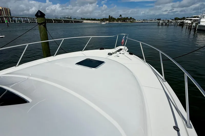 Slide: The Image of 2006 Tiara Yachts 3900 Convertible boat docked in a scenic marina setting. - 41