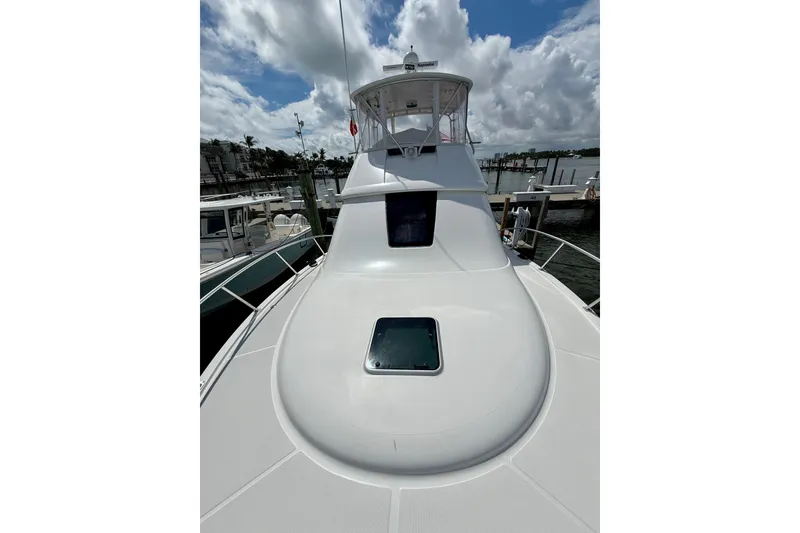 Slide: The Image of 2006 Tiara Yachts 3900 Convertible boat deck under cloudy sky at marina. - 43