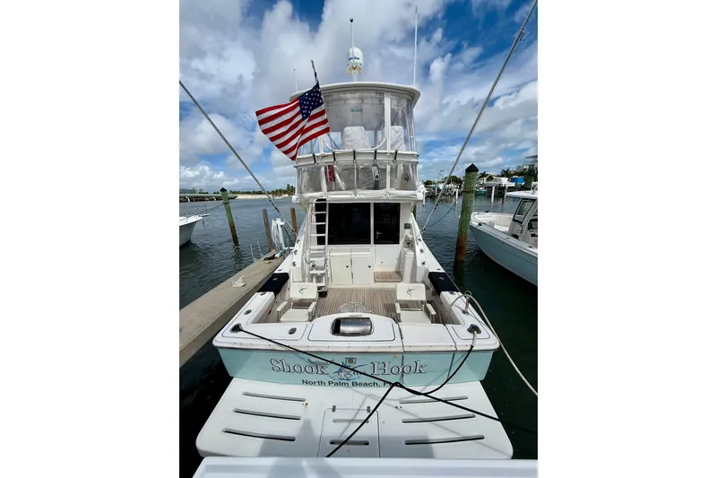 Slide: The Image of 2006 Tiara Yachts 3900 Convertible docked, displaying American flag, North Palm Beach. - 53