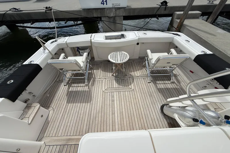 Slide: The Image of 2006 Tiara Yachts 3900 Convertible deck with seating and table, docked at marina. - 7