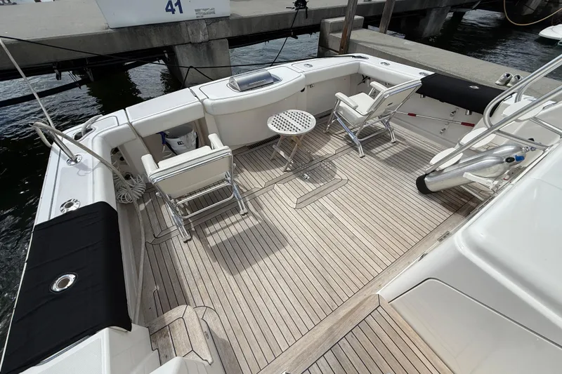 Slide: The Image of 2006 Tiara Yachts 3900 Convertible deck with seating and table, docked at marina. - 8
