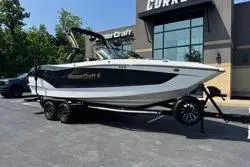 The Image of 2025 MasterCraft X24 boat on trailer outside dealership. - 13