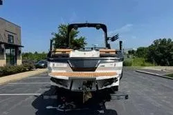 Slide: The Image of 2025 MasterCraft X24 boat in parking lot, rear view, sunny day. - 16