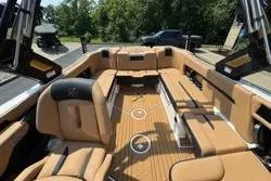 Slide: The Image of 2025 MasterCraft X24 boat interior with luxurious tan seating and sleek design. - 18