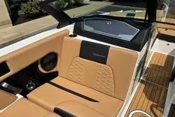 Slide: The Image of 2025 MasterCraft X24 boat interior with tan leather seating and modern design. - 19