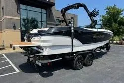 Slide: The Image of 2025 MasterCraft X24 boat on trailer in parking lot, side view. - 20