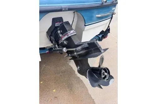 Slide: The Image of 1995 Chaparral 1930 SS boat with MerCruiser outboard motor, docked on concrete surface. - 4