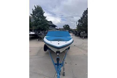 Slide: The Image of 1995 Chaparral 1930 SS boat on trailer, blue cover, outdoor setting. - 5