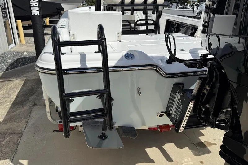 Slide: The Image of 2026 Blazer PureBay 2400 boat rear view with ladder and motor details. - 10